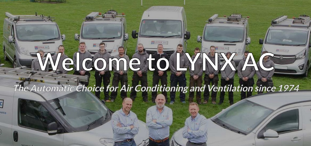 Photo taken of Lynx AC team members and their branded vehicles